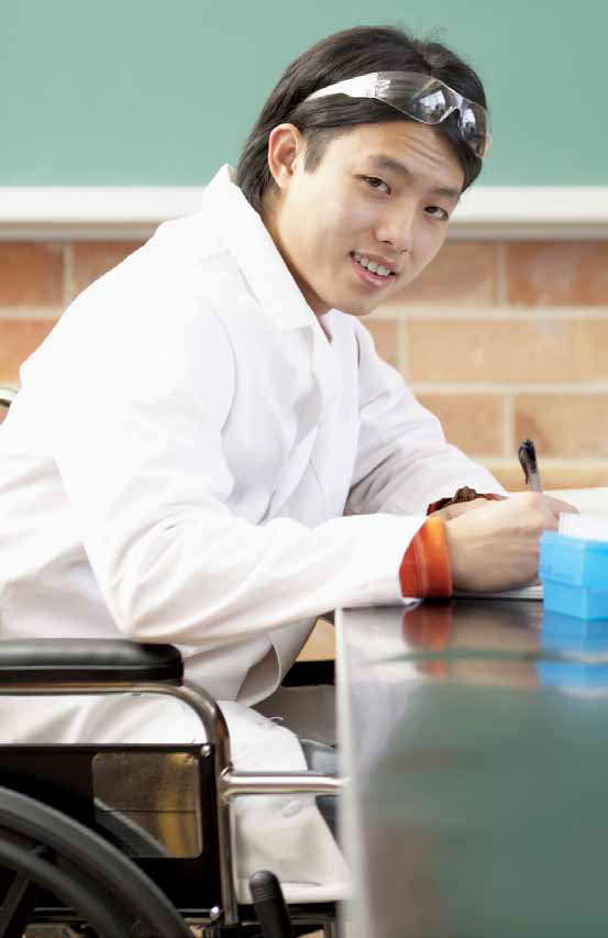 a photo of a student wearing a lab coat and eye protection looking at the camera quizzically