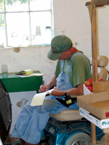 a photo of a tomato farmer filling out paper work