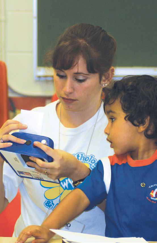 a photo of a woman showing a child a device considered assistive technology