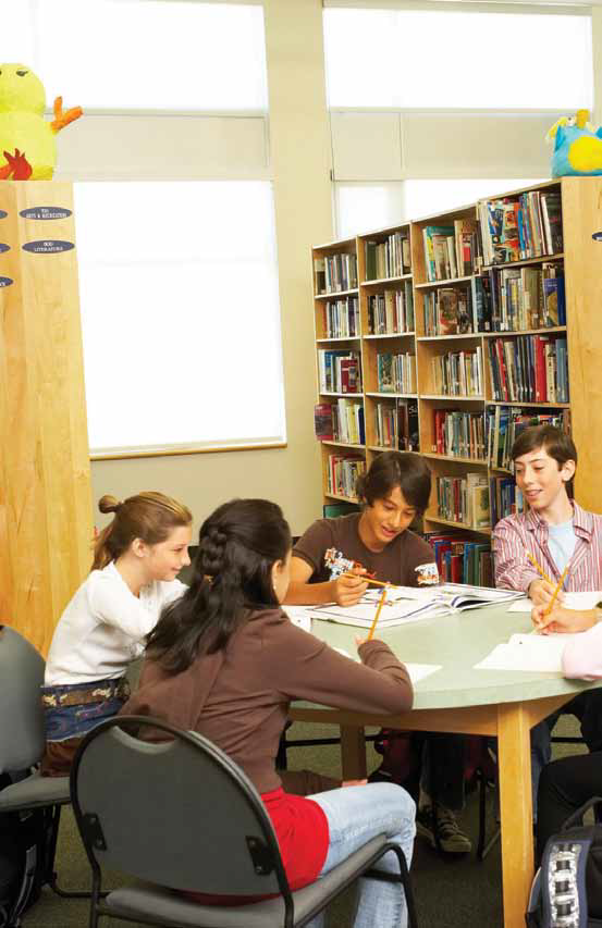 photo of a group of students researching in the library