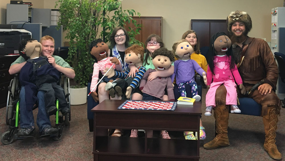 a photo of Colson with the CED Music Therapy puppets team