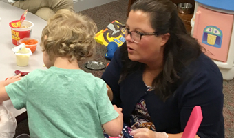 a photo of our team working with a diverse group of children