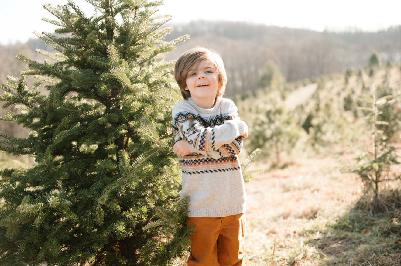 a photo of Waylon posing beside a tree