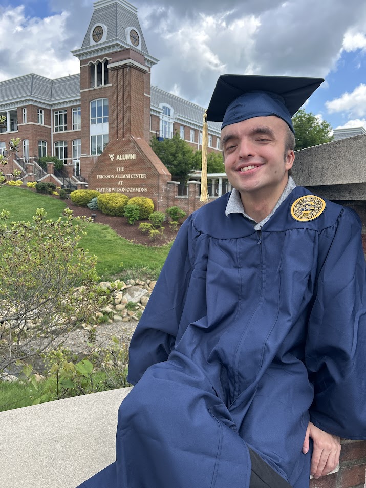 a Country Roads grad in front of the Alumni Center